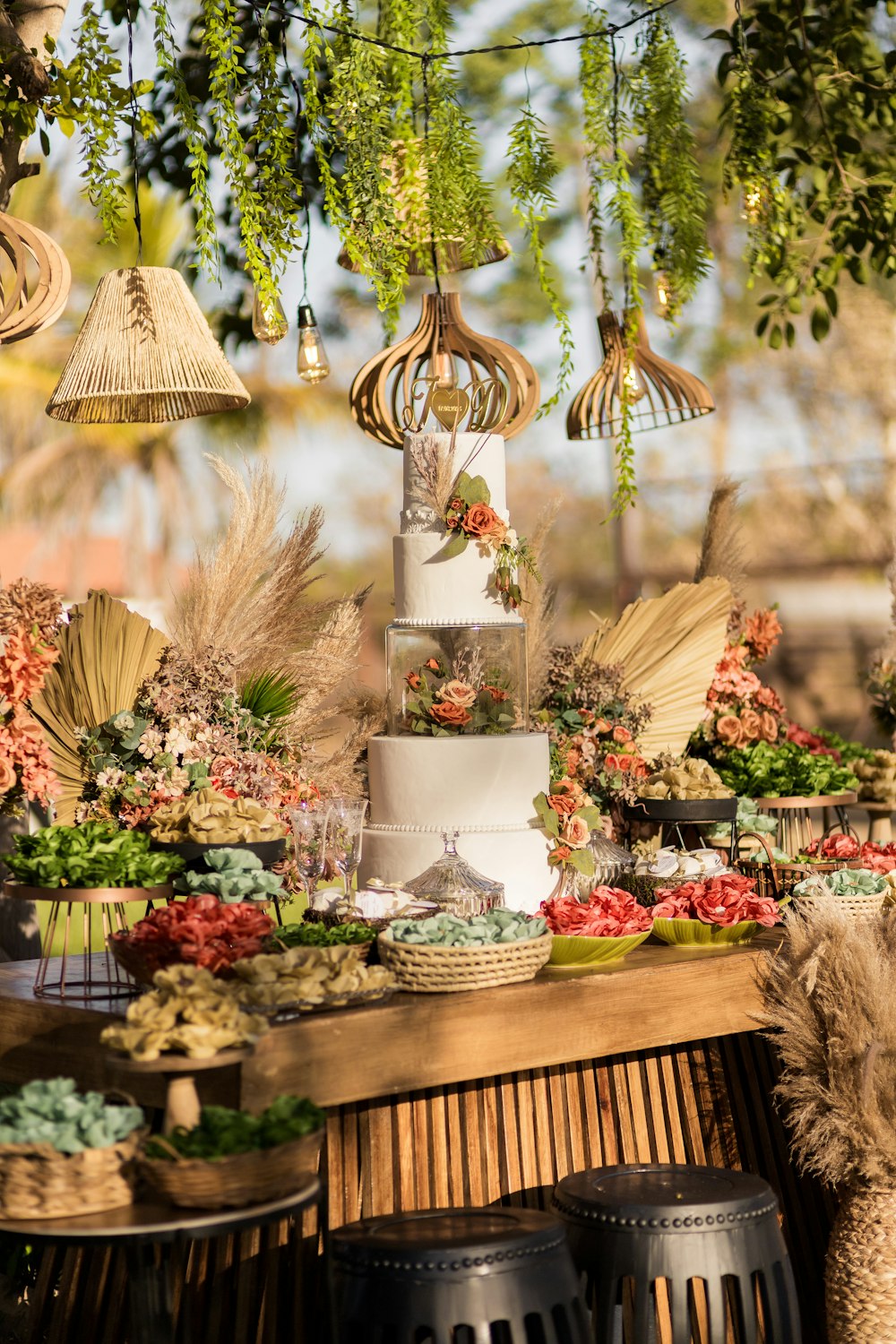 a table topped with a white cake covered in flowers