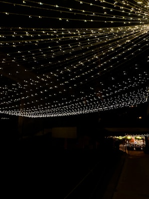 A cozy inflatable lounge area decorated with fairy lights for a night gathering.