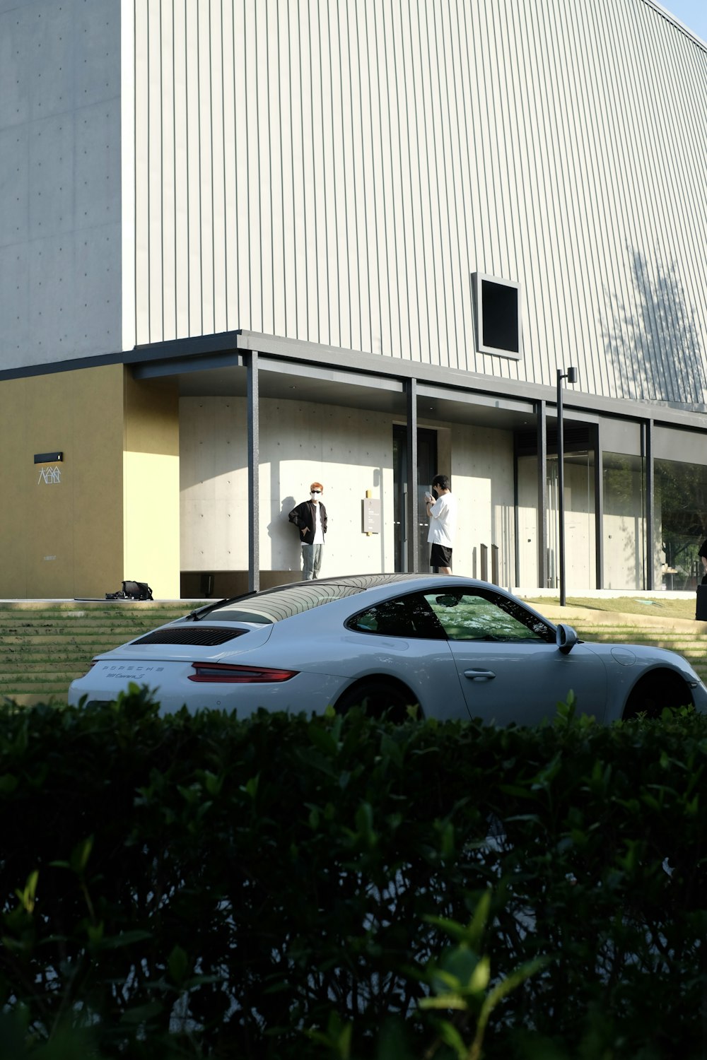 a white car parked in front of a building