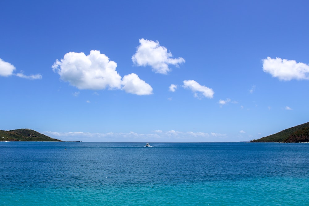 a body of water with a boat in the distance