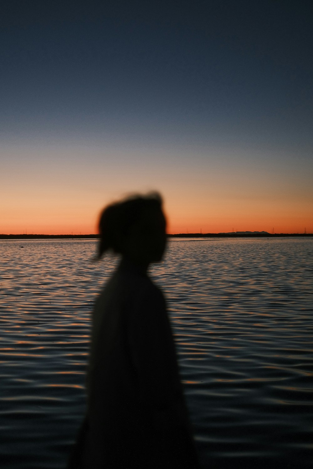 a person standing in front of a body of water