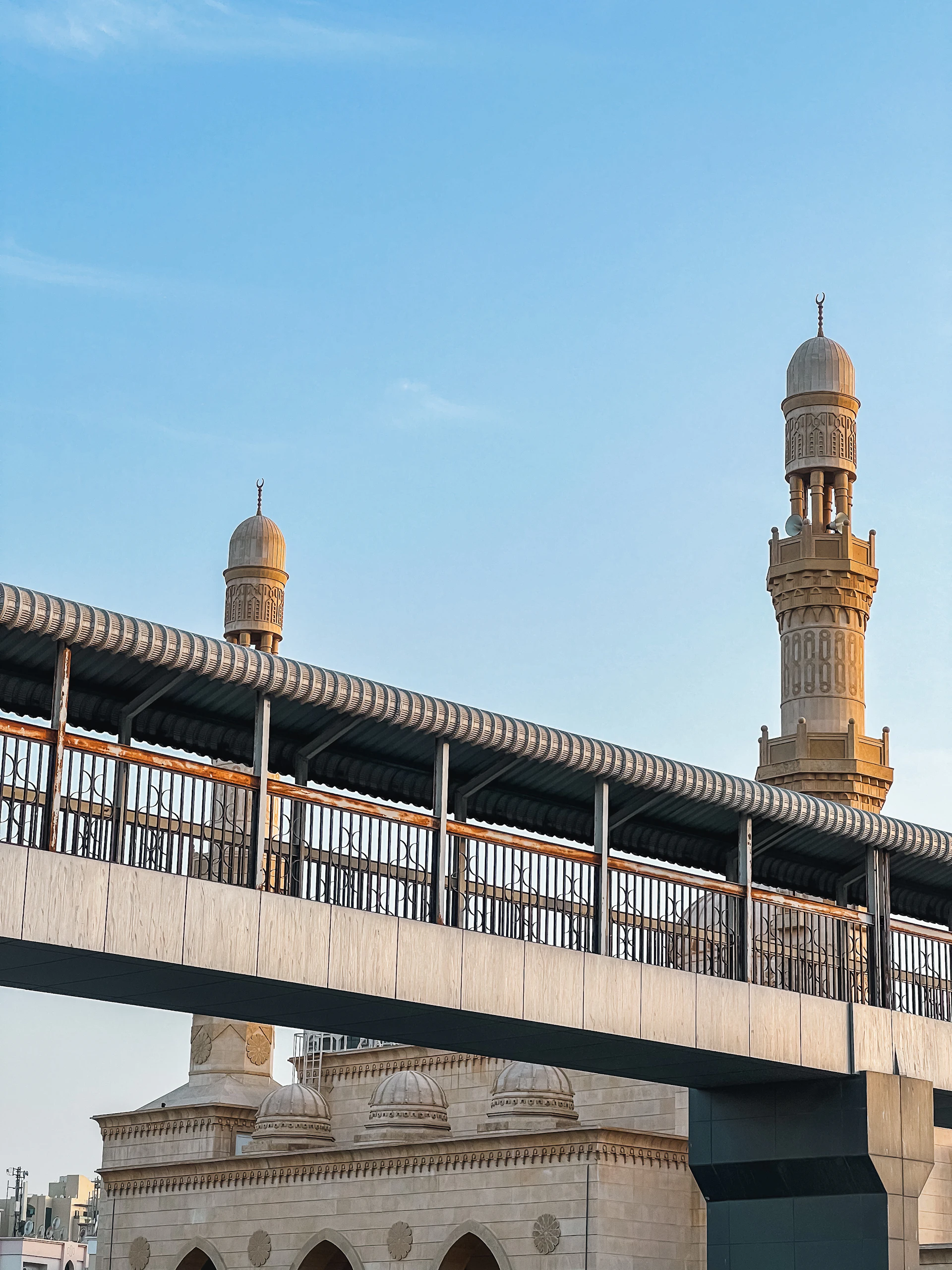 Waterfront footbridge and minaret on the northern Emirates coast
