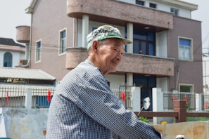 A veteran standing proudly in front of their new home.