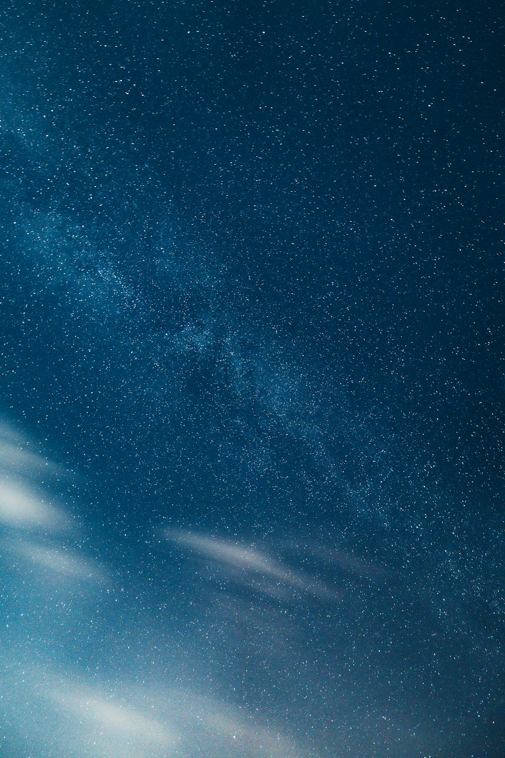 a night sky with stars and clouds