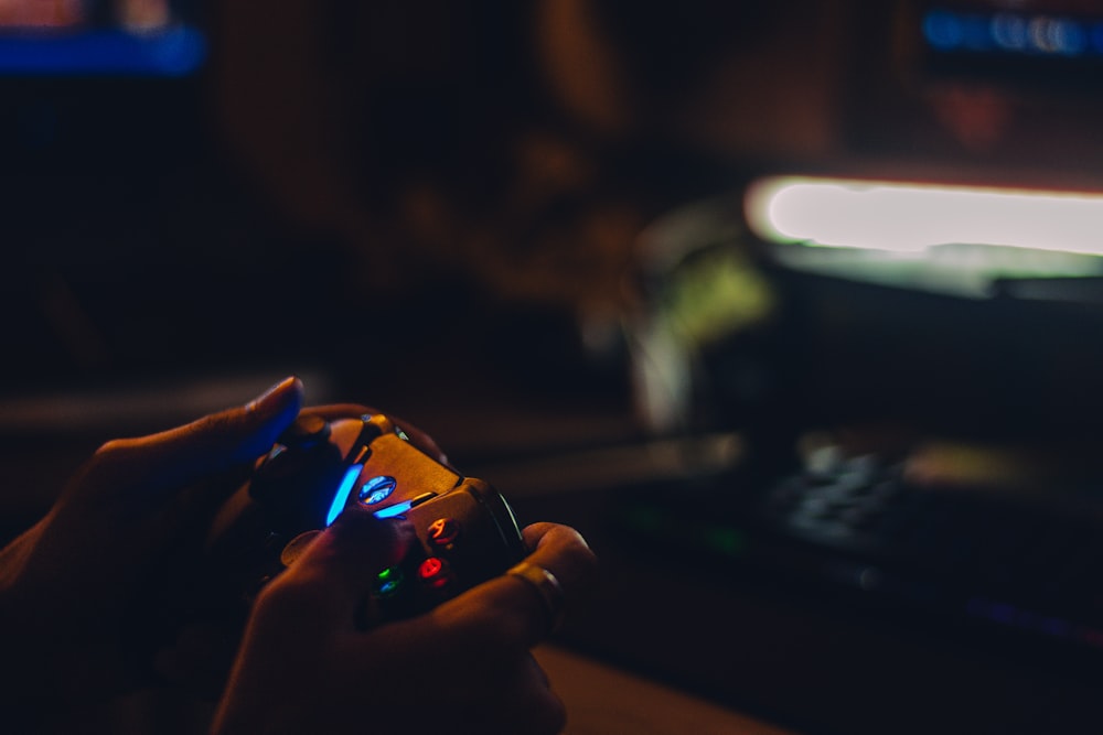 a person holding a game controller in their hand