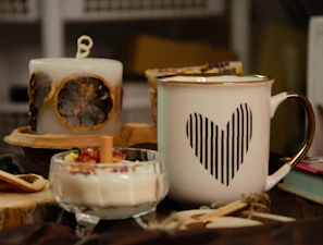 A festive hamper wrapped in eco-friendly materials showcasing luxury candles, preserves, and a stylish mug