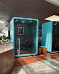 a bathroom with a blue wall and a wooden floor