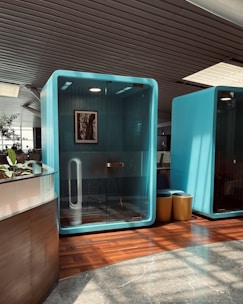 a bathroom with a blue wall and a wooden floor