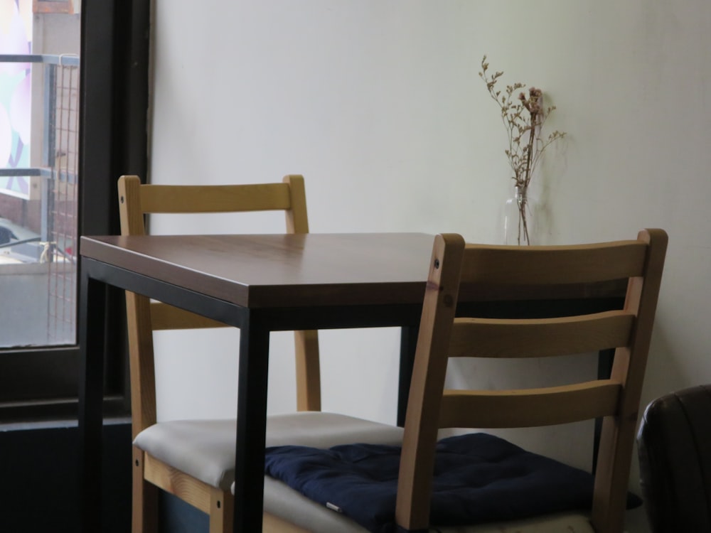 a table with two chairs next to a window