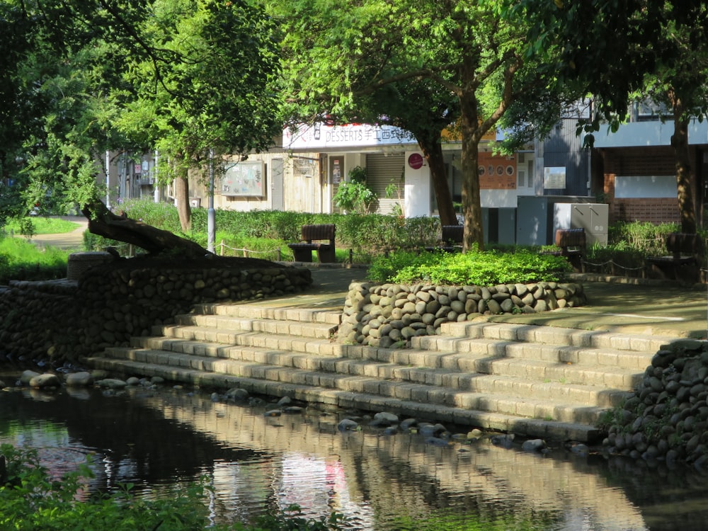 a set of stone steps next to a body of water