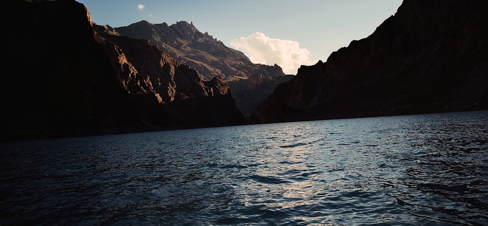 a body of water with mountains in the background