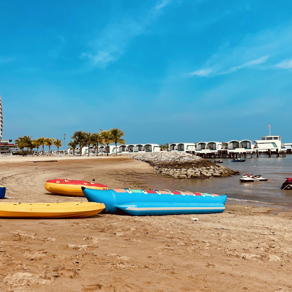 a group of boats sitting on top of a sandy beach