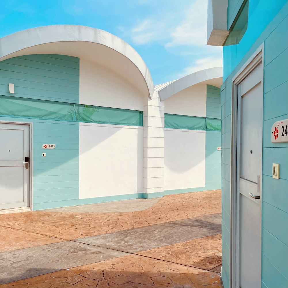 a blue and white building with two white doors