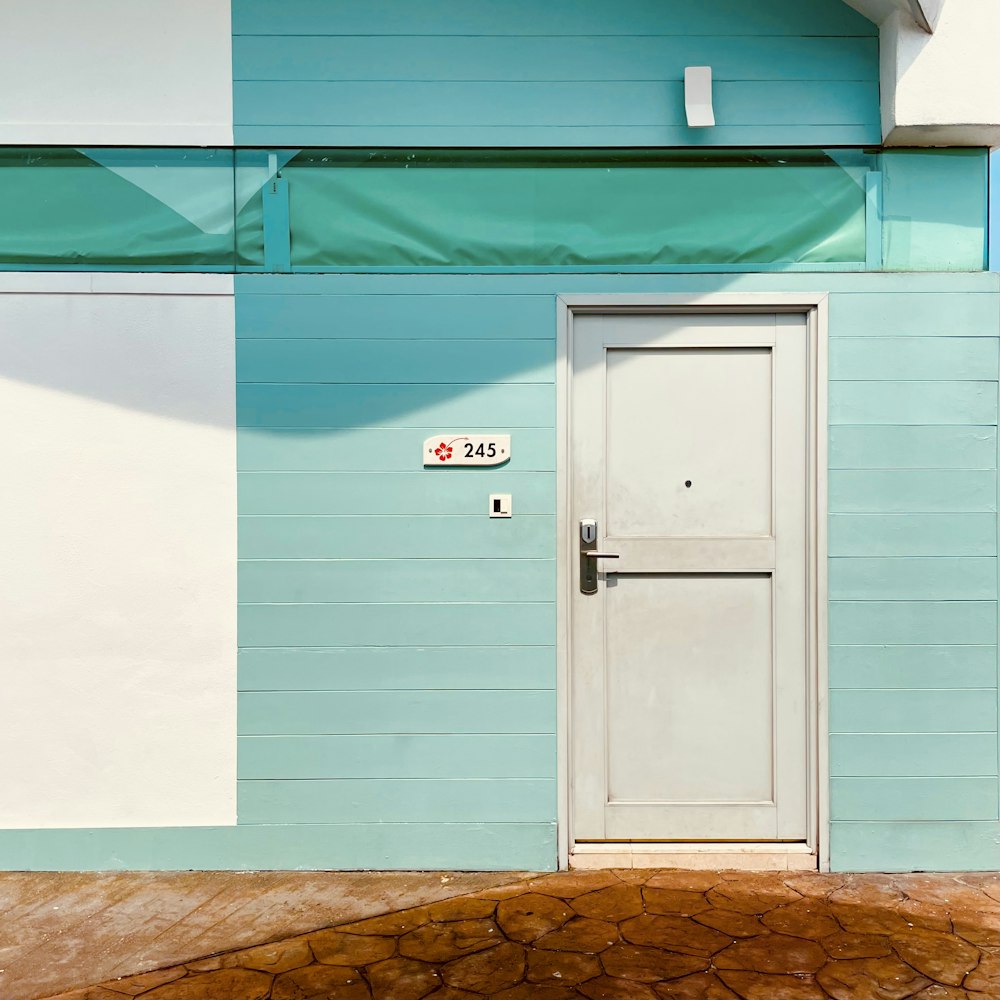 a blue and white building with a white door