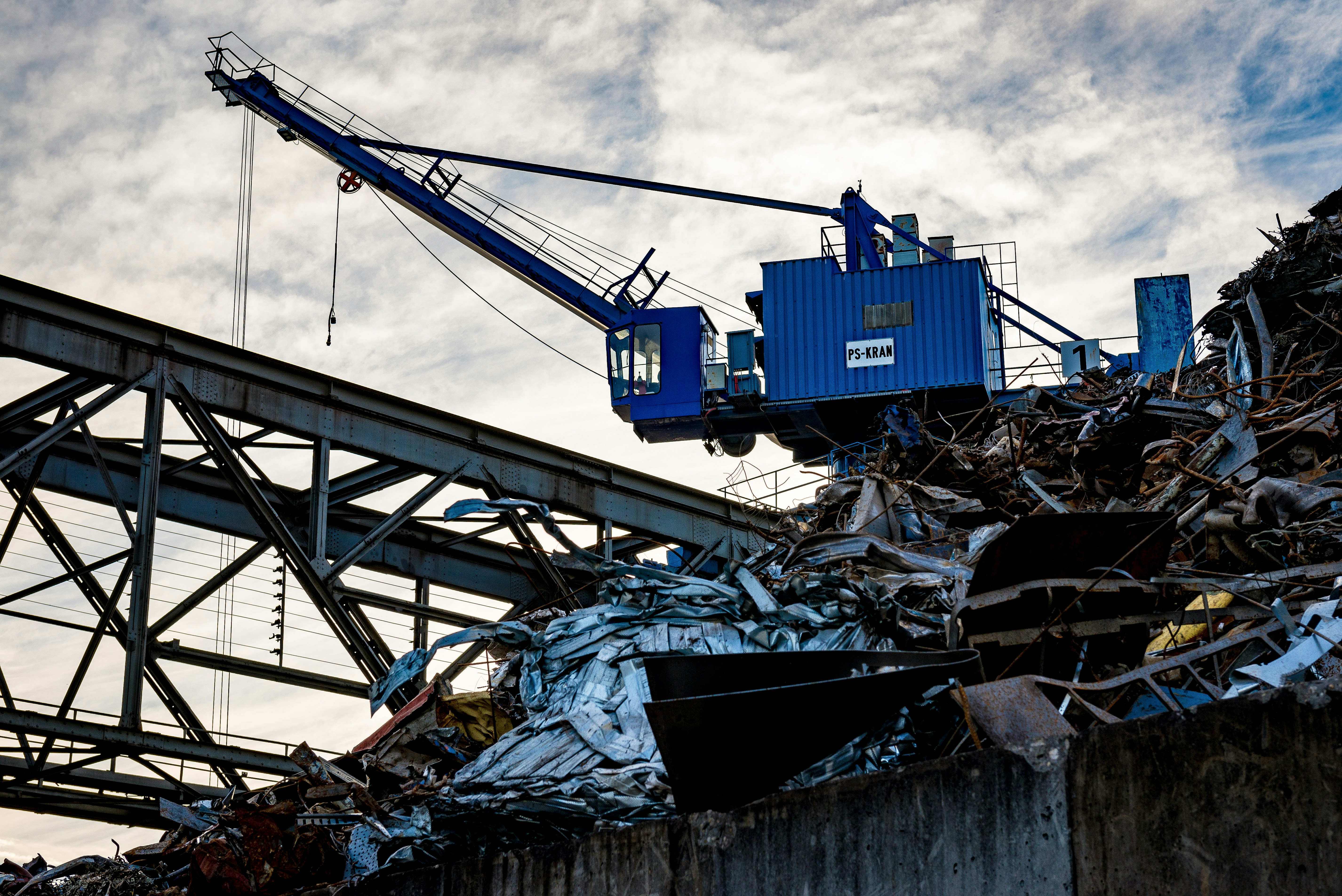 a crane is lifting a large pile of junk