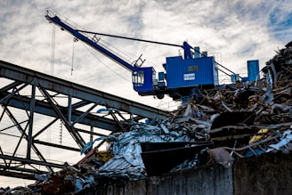 a crane is lifting a large pile of junk