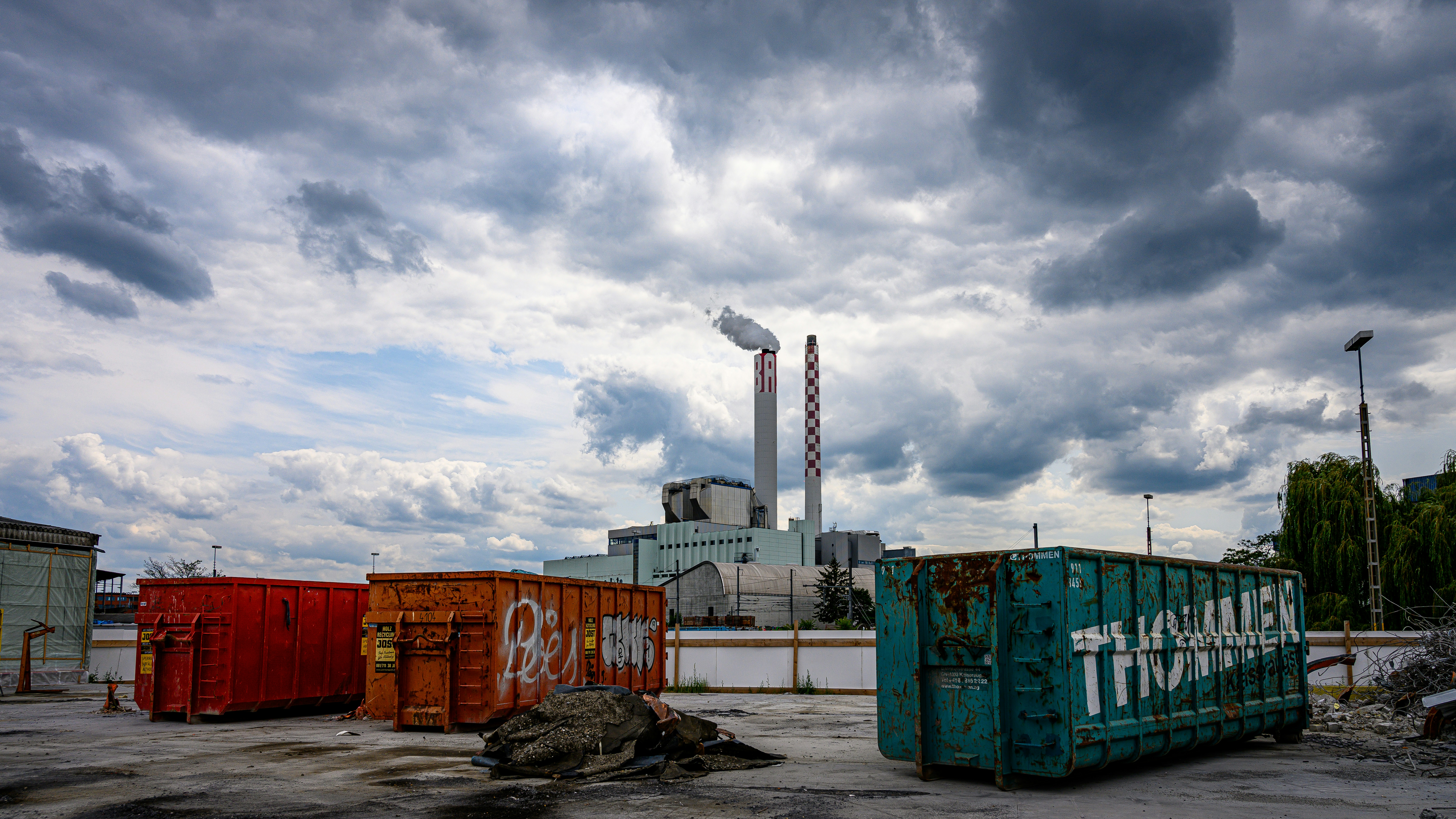 A group of shipping containers sitting in front of a factory photo ...