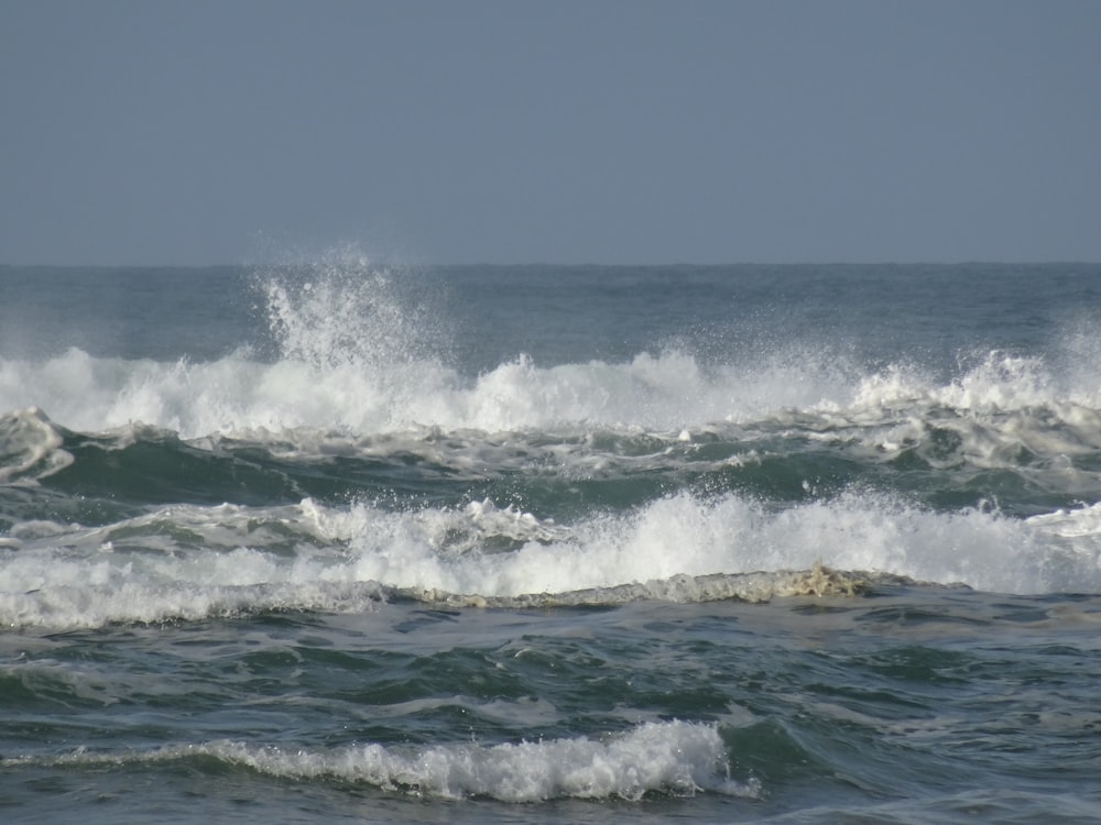 a person riding a surfboard on a wave in the ocean