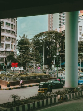 A bustling street scene outside a residential building in Bandra.