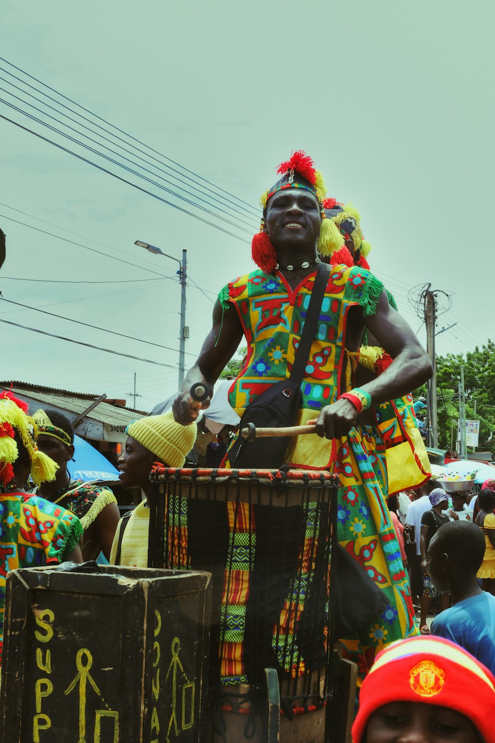 a man in a colorful costume riding on a cart