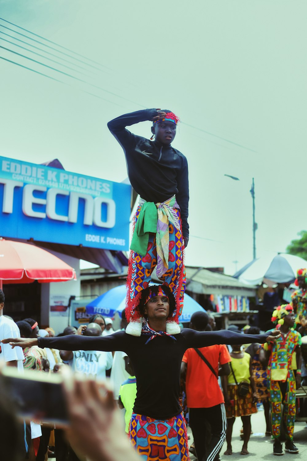 a man standing on top of a woman in a colorful dress
