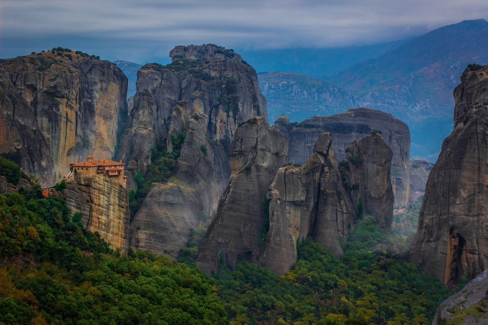 a group of mountains with a house in the middle of them