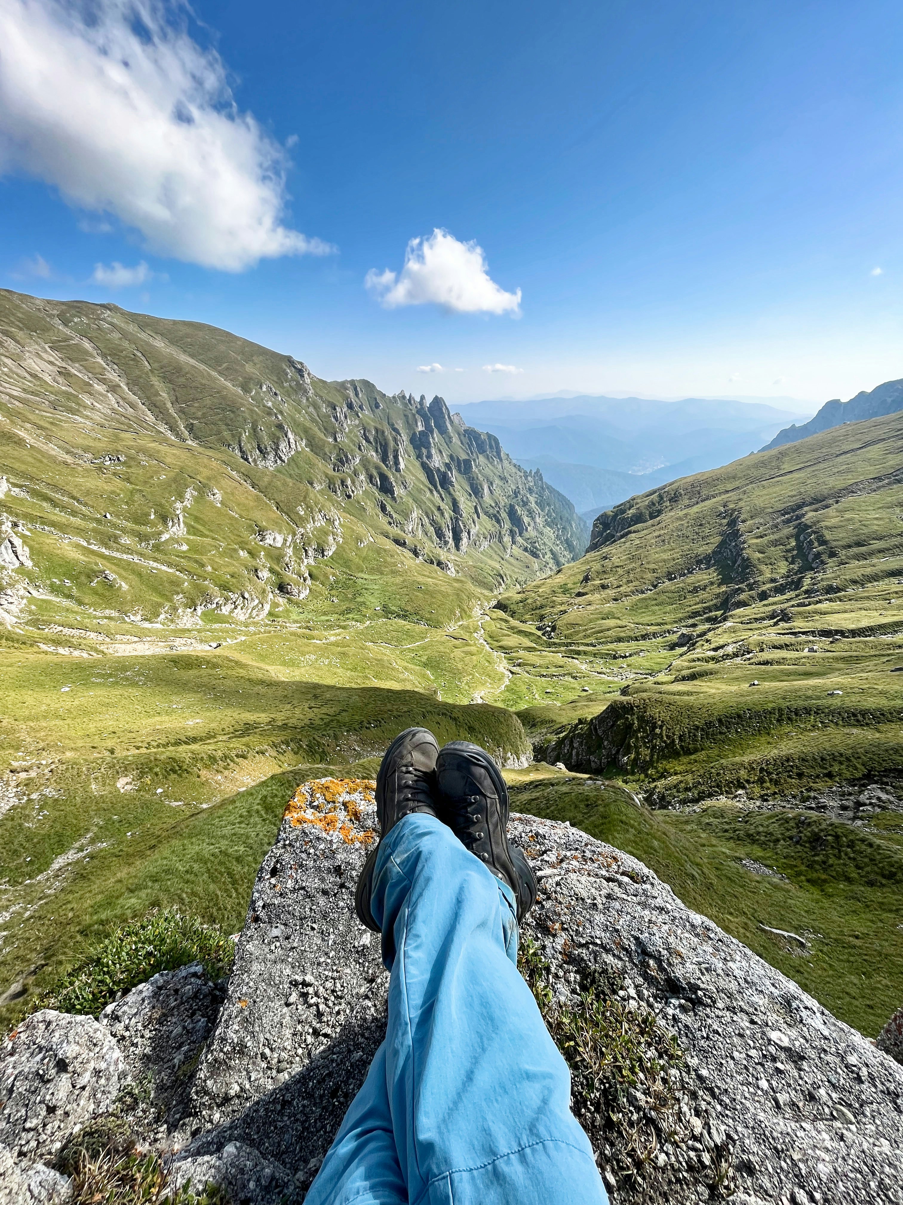 a person laying on top of a large rock