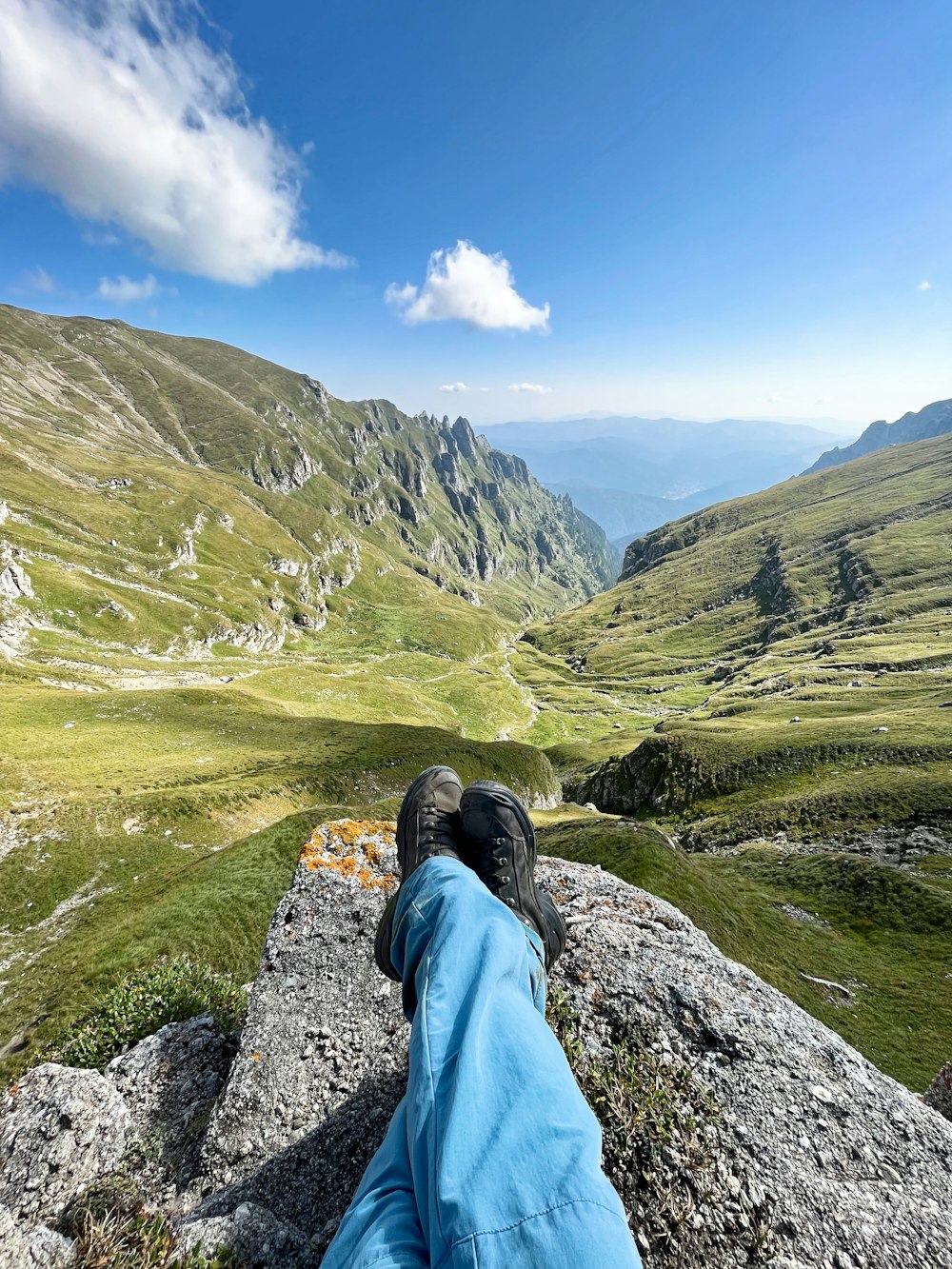 a person laying on top of a large rock