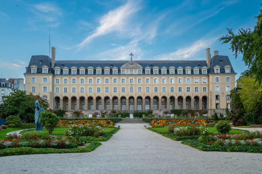 a large building with a garden in front of it