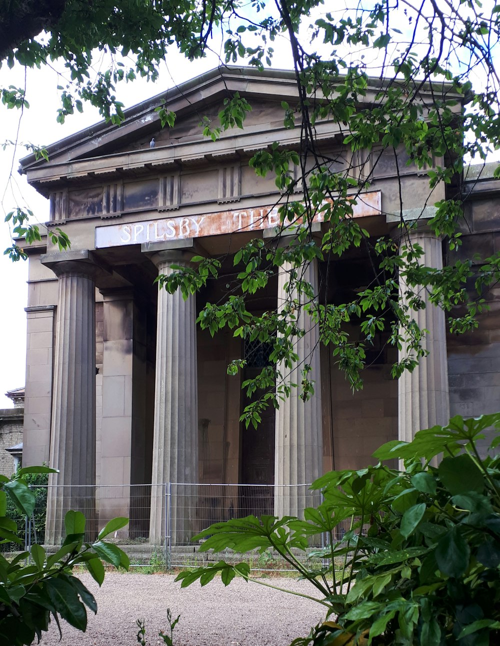 a large building with columns and a sign above it