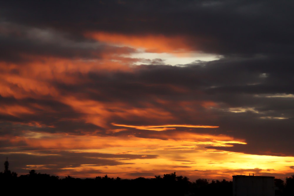 the sun is setting over the horizon of a city