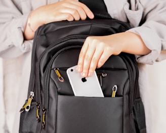 A traveler easily folding the organizer to fit into a backpack pocket.
