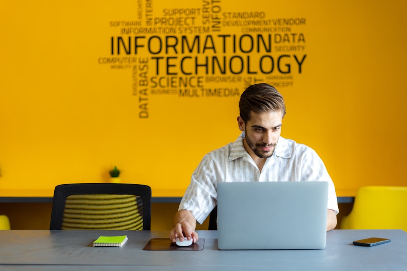 a man sitting in front of a laptop computer