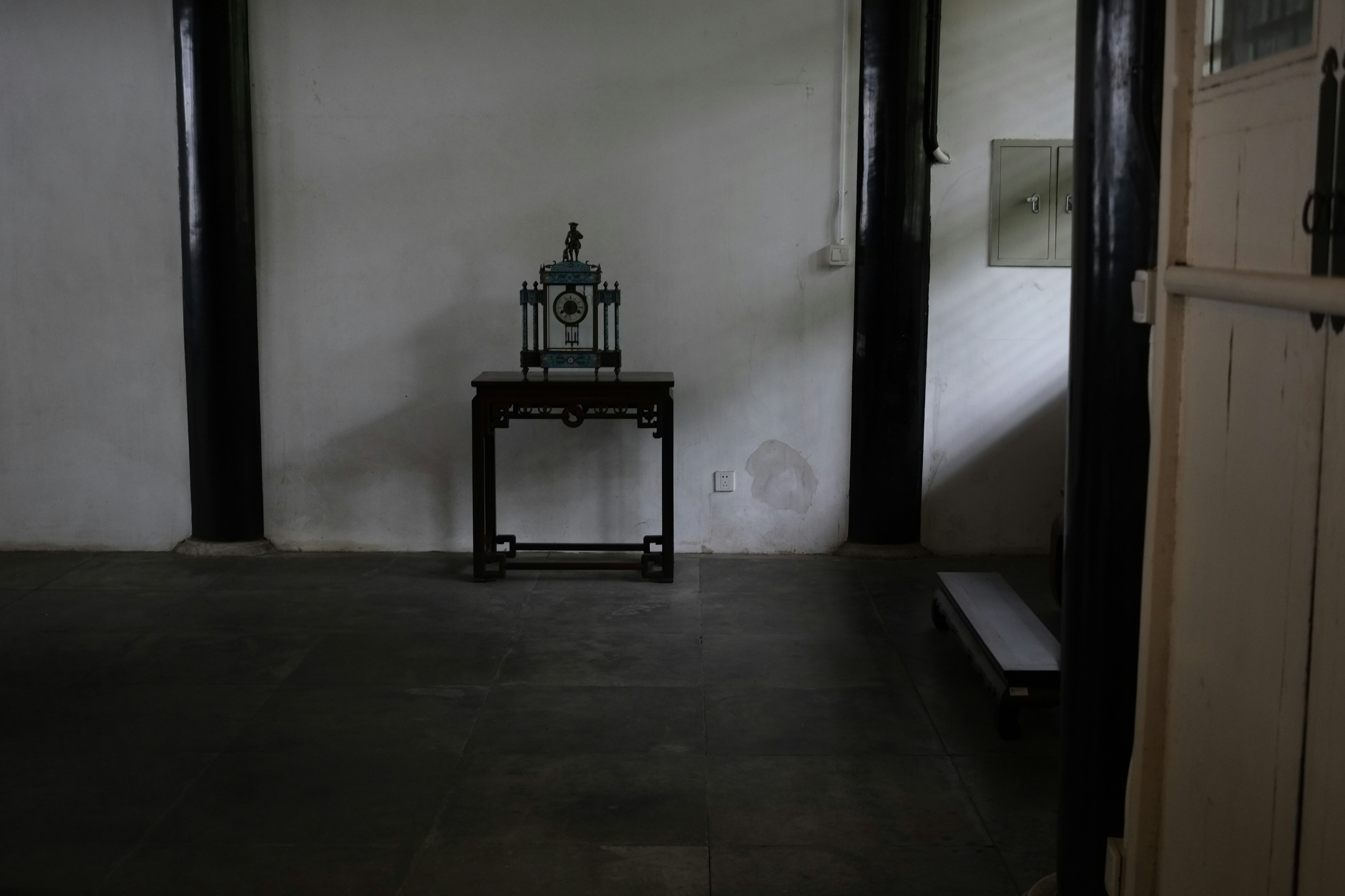 a table with a clock on top of it in a room