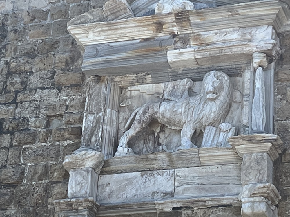 a close up of a statue on a building