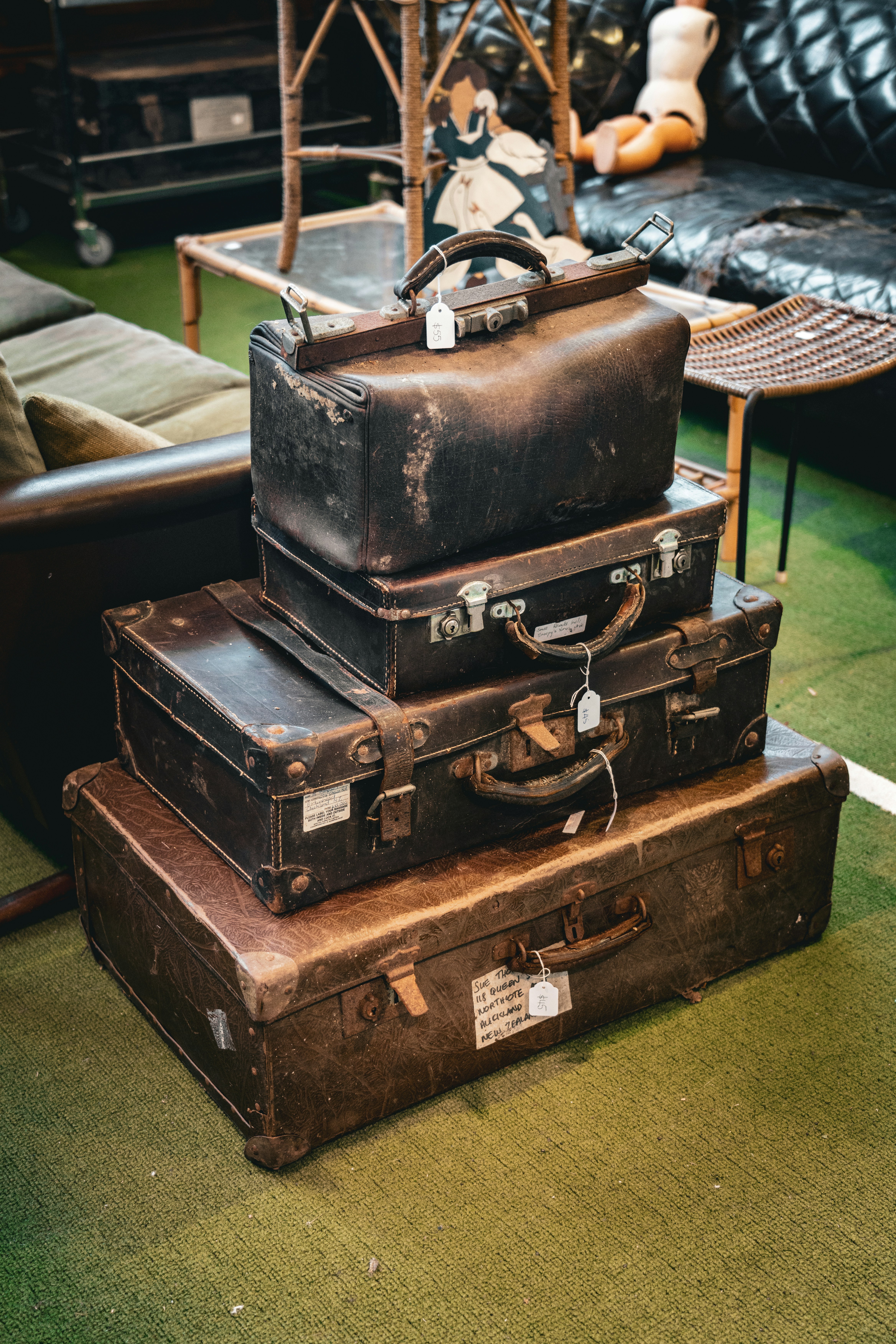 a pile of luggage sitting on top of a green floor