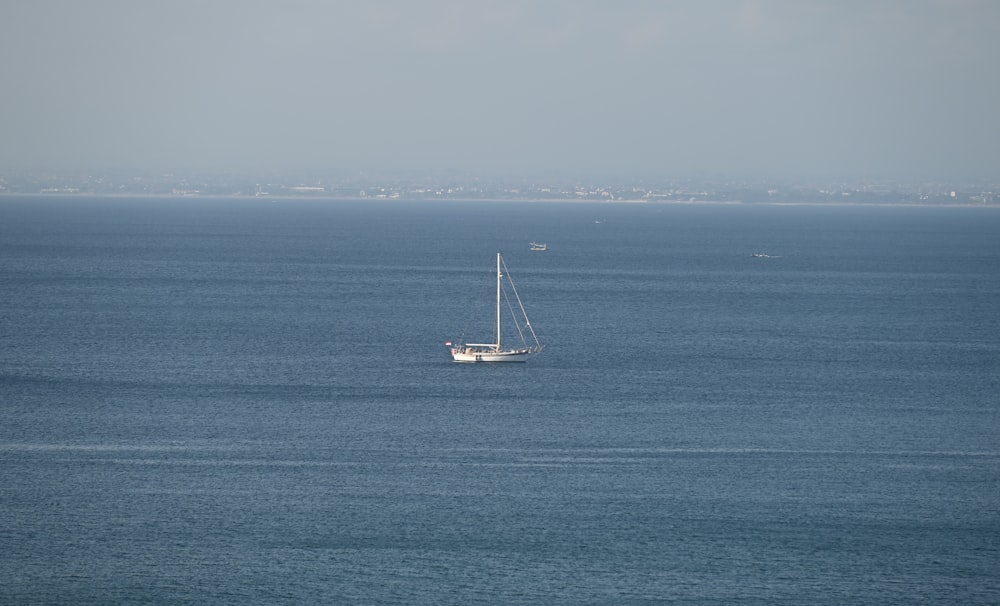 a sailboat in the middle of the ocean