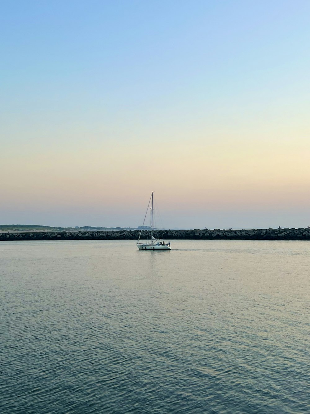 a sailboat floating in the middle of a large body of water