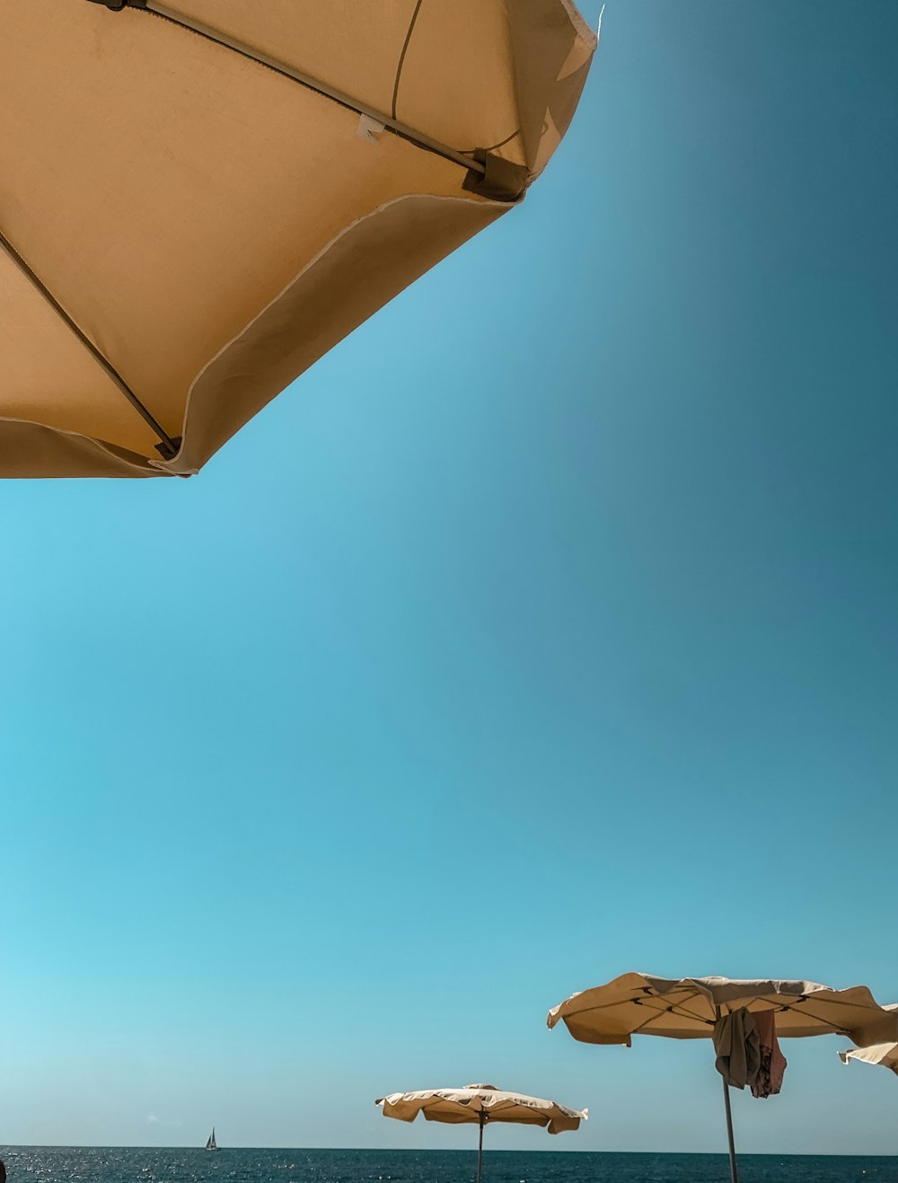 a beach with umbrellas and chairs on a sunny day