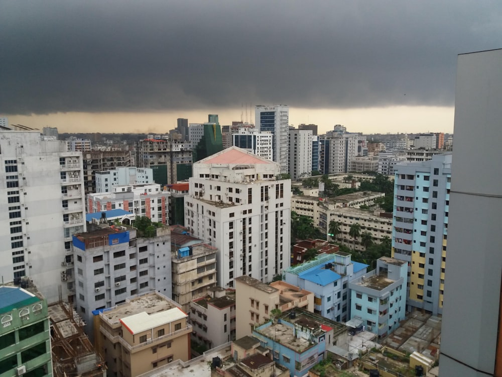 a city with tall buildings under a cloudy sky