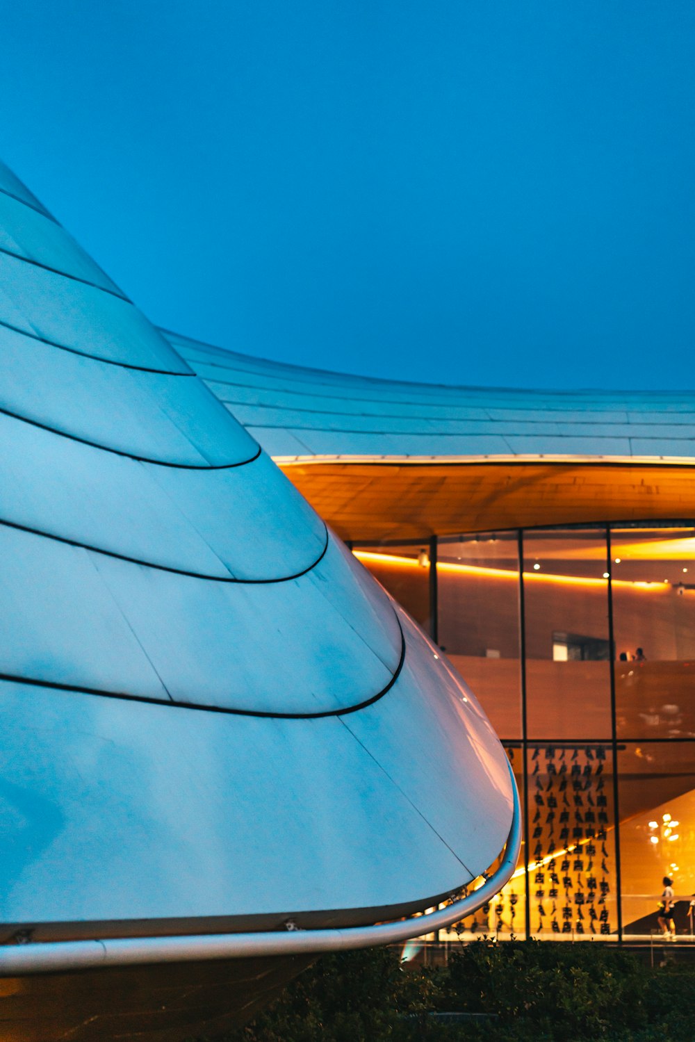 a building with a curved roof at night