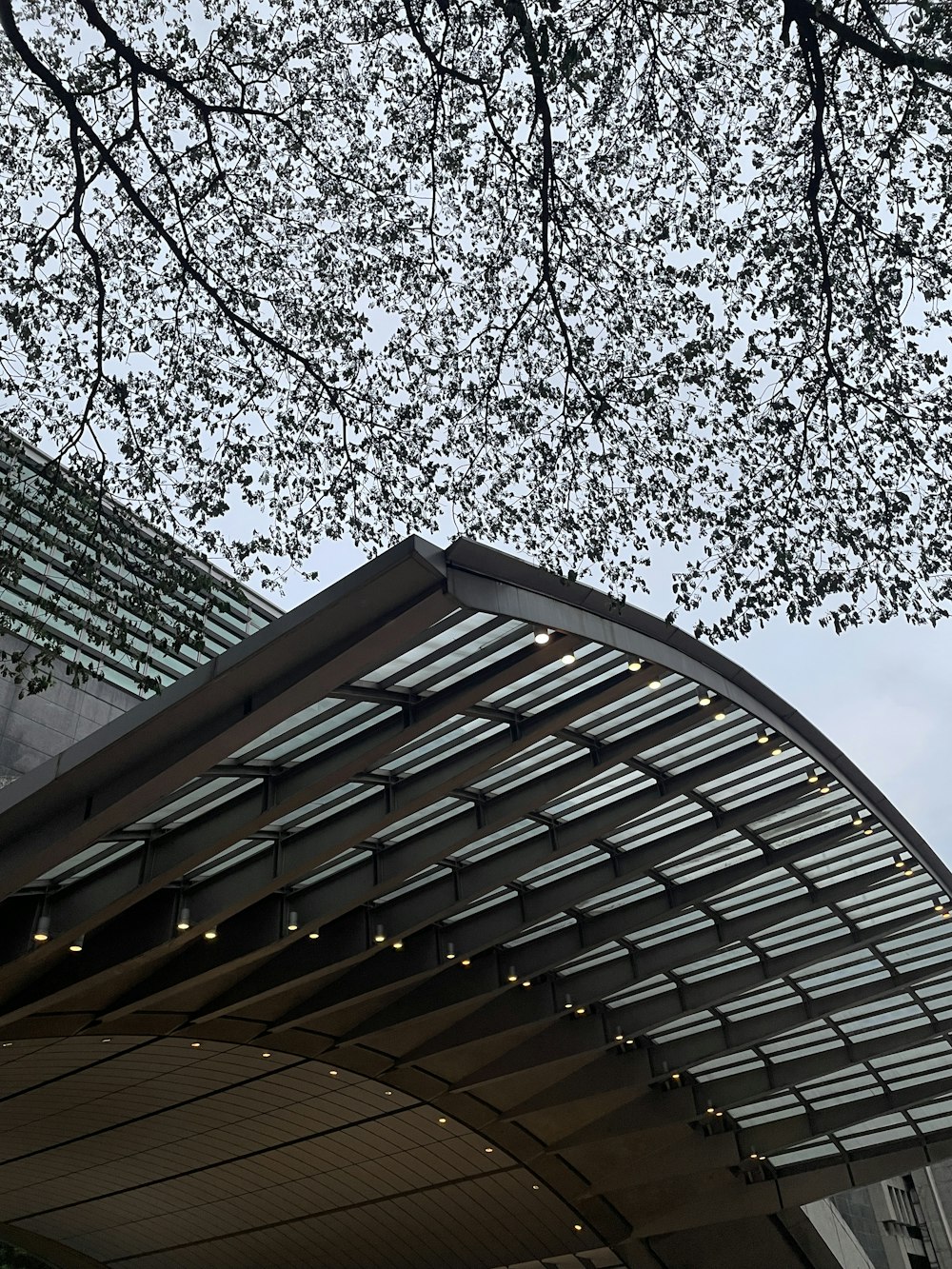 a building with a canopy and a clock on the side of it