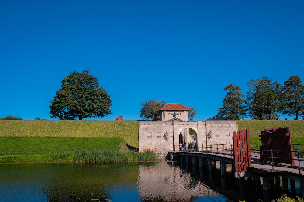 a bridge over a body of water with a building in the background