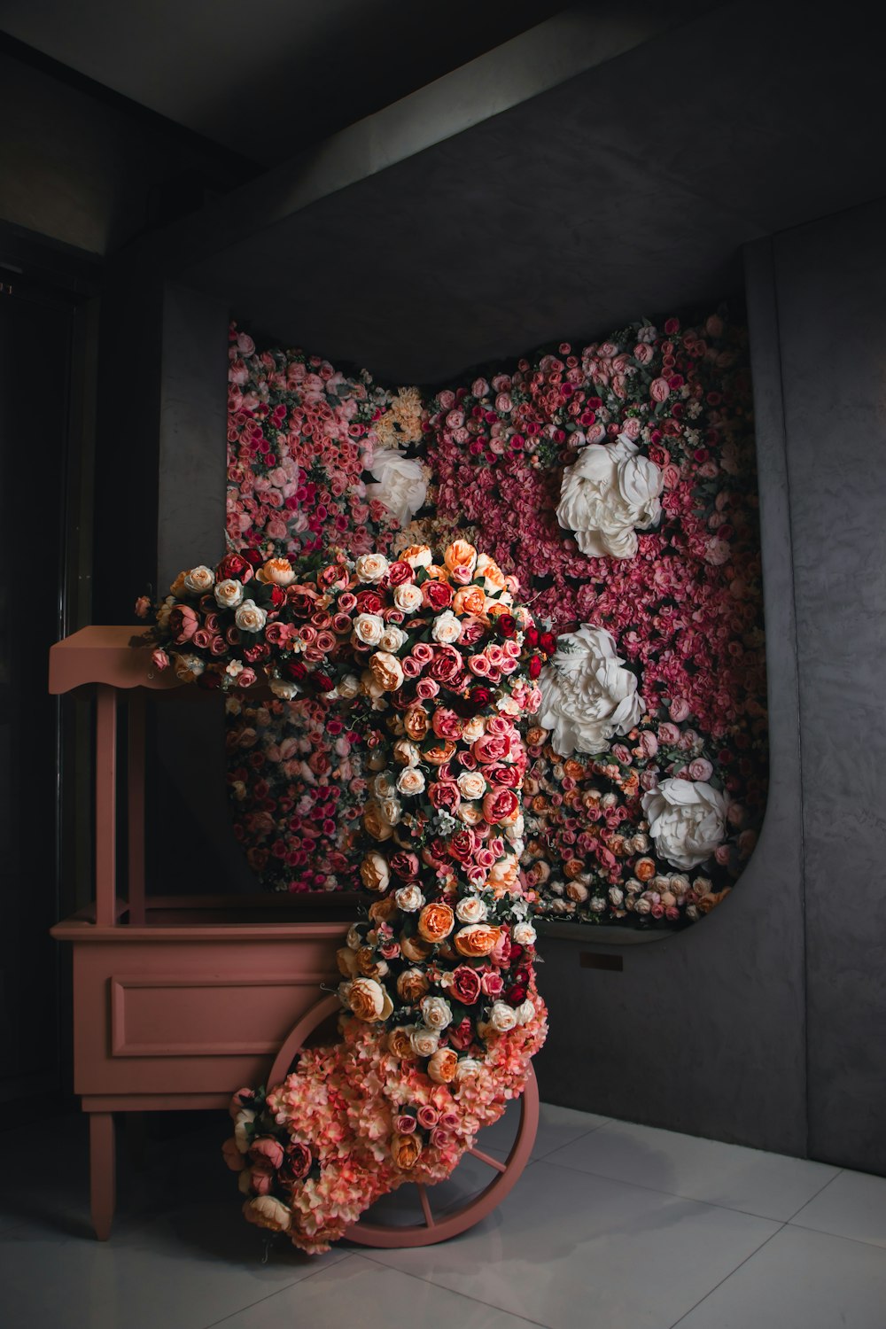 a sculpture of a person made out of flowers