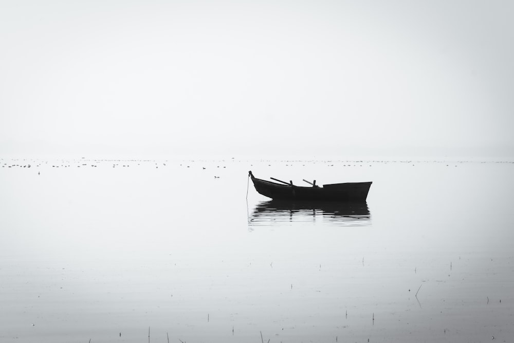 a boat floating on top of a large body of water