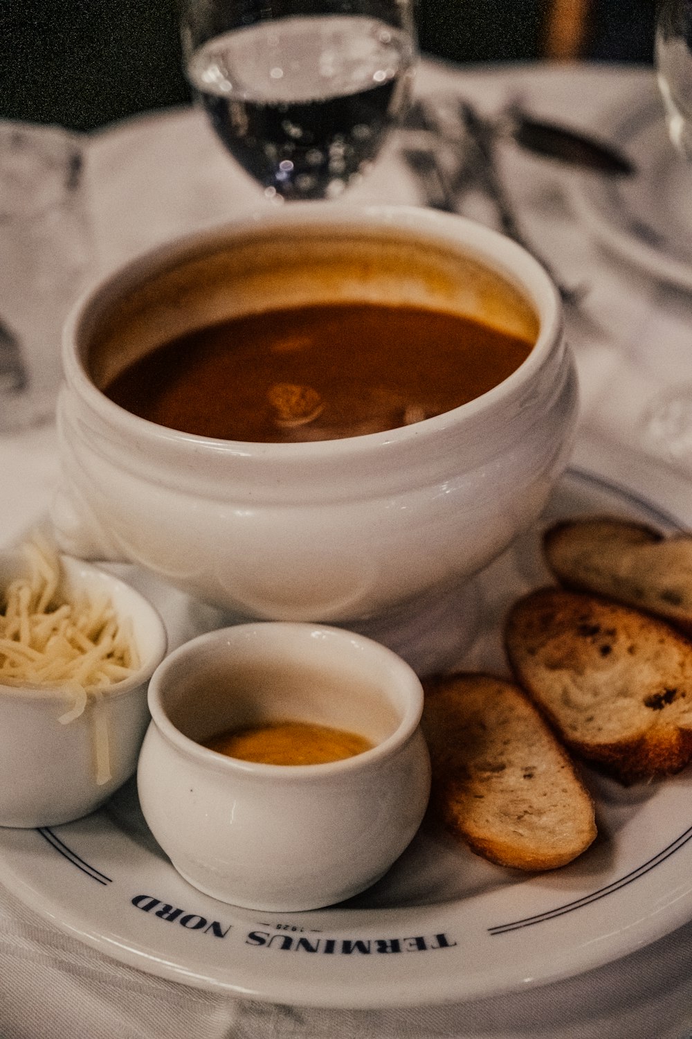 a white plate topped with soup and bread