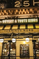 a store front with a neon sign above it