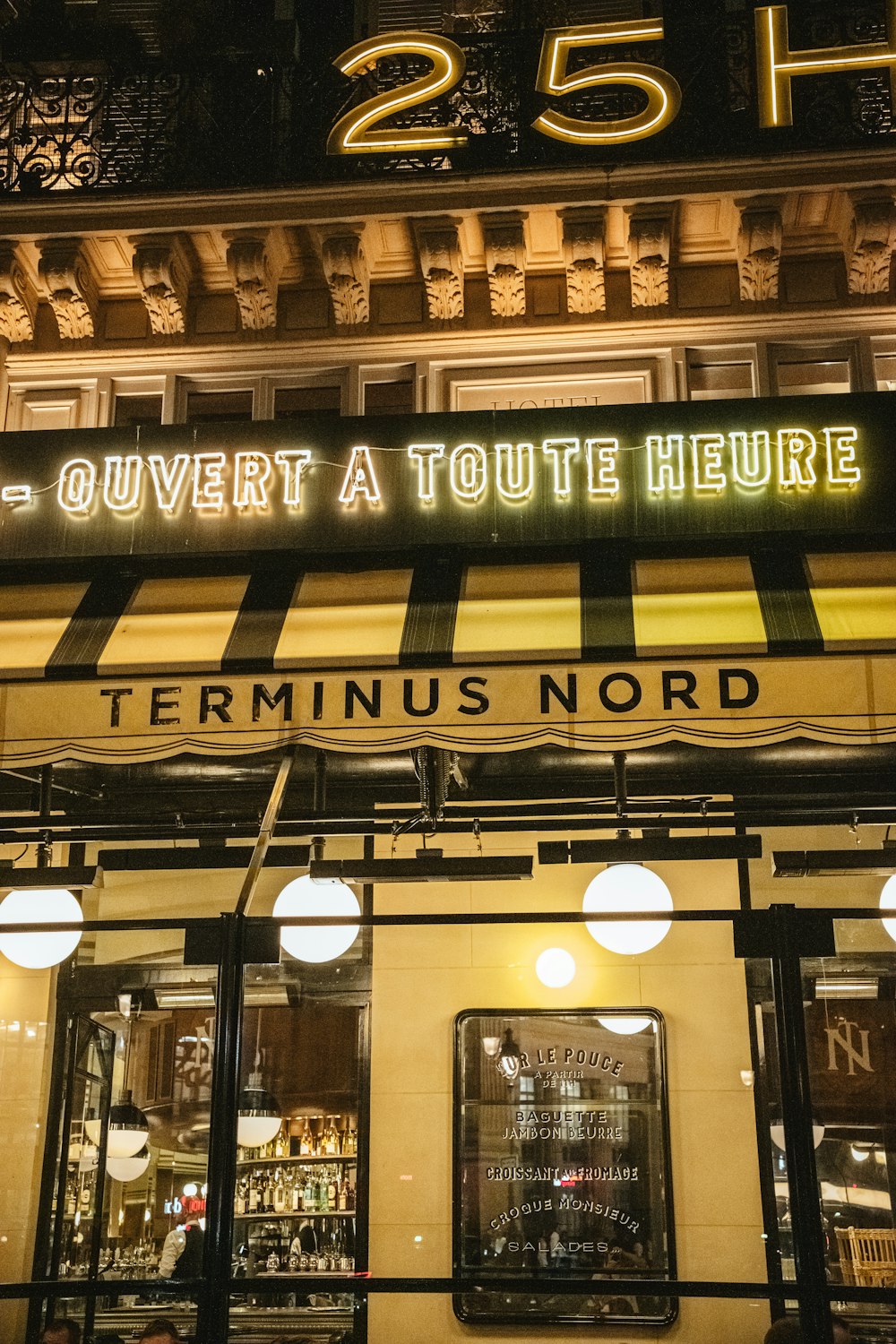 a store front with a neon sign above it