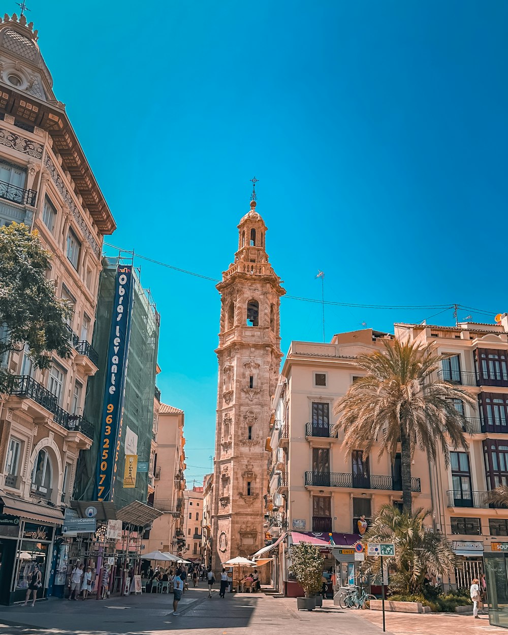 a tall clock tower towering over a city street