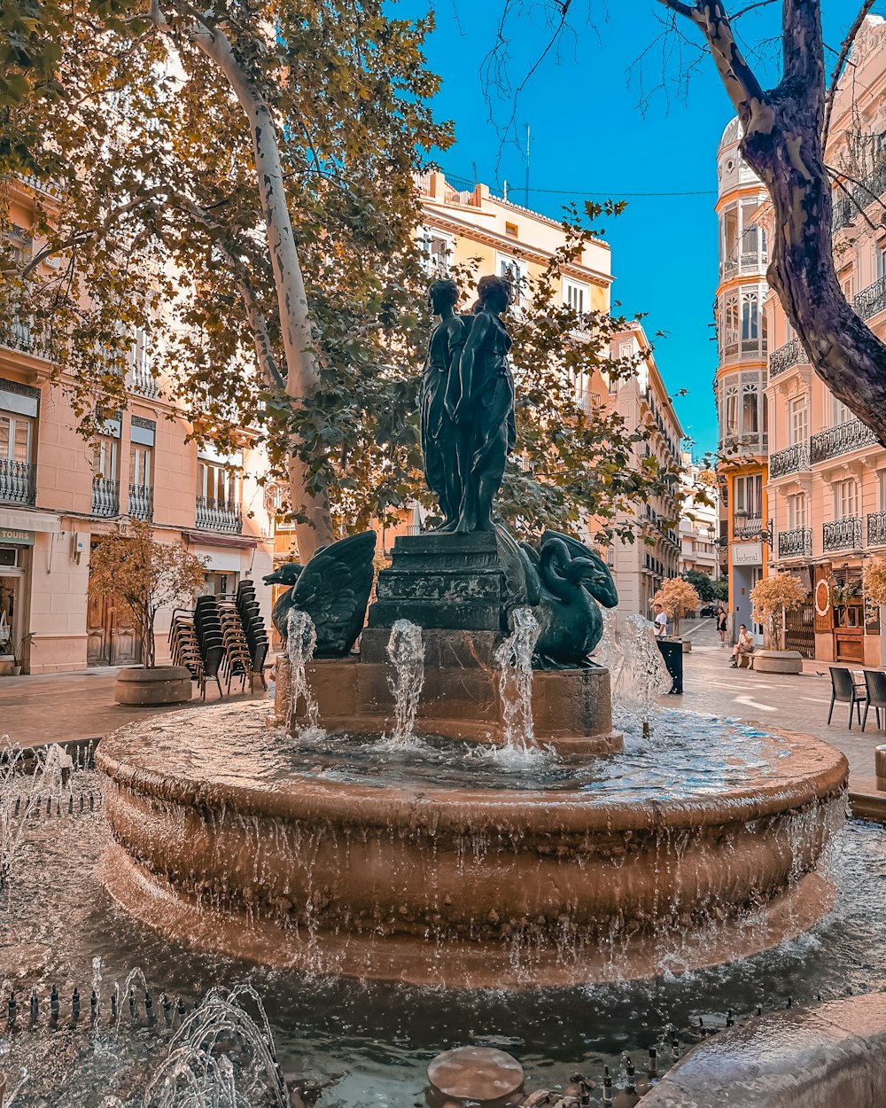 a fountain in the middle of a city square